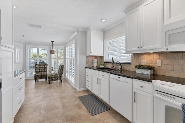 kitchen featuring sink, white appliances, white cabinets, and a wealth of natural light