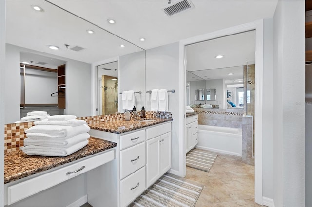 bathroom featuring vanity and separate shower and tub