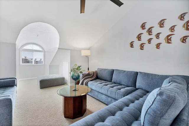 living room featuring lofted ceiling and carpet flooring