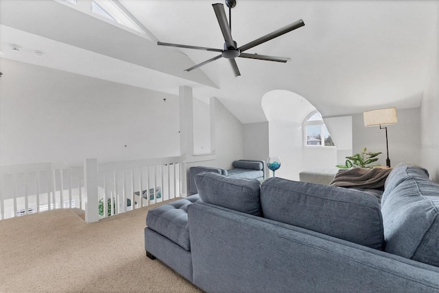 living room with ceiling fan, carpet floors, and lofted ceiling