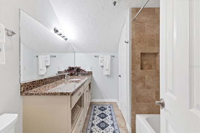 bathroom featuring a textured ceiling, toilet, and vanity