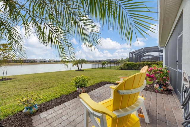 view of patio with glass enclosure and a water view