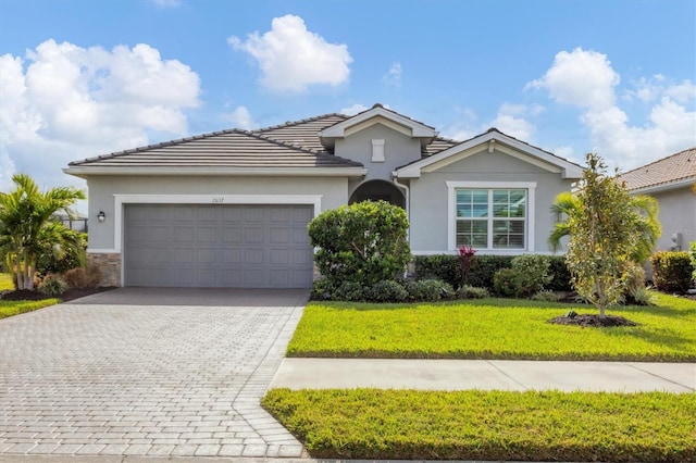 view of front facade featuring a garage and a front lawn