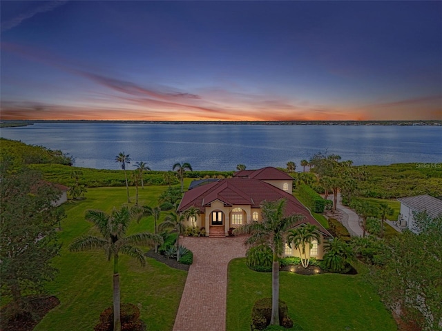 aerial view at dusk with a water view