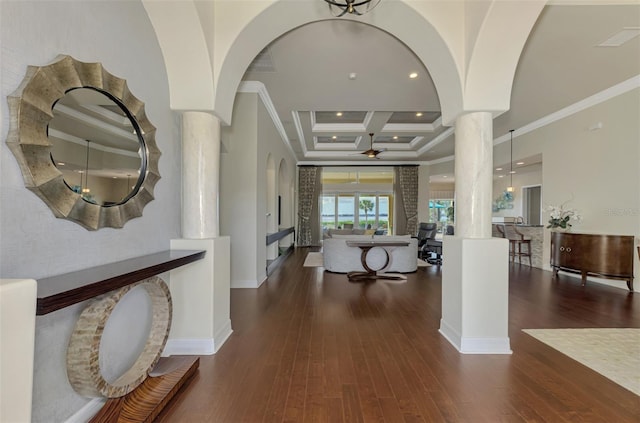 hallway featuring dark hardwood / wood-style floors, ornate columns, ornamental molding, and coffered ceiling