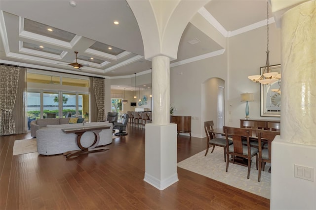 living room featuring a high ceiling, coffered ceiling, and ornamental molding