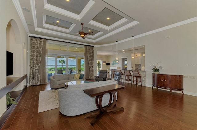 living room with dark wood-type flooring, crown molding, and coffered ceiling