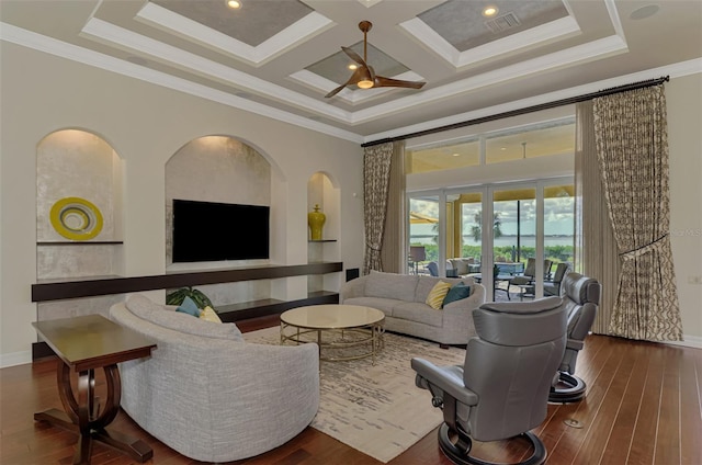 living room with ceiling fan, coffered ceiling, crown molding, a towering ceiling, and wood-type flooring