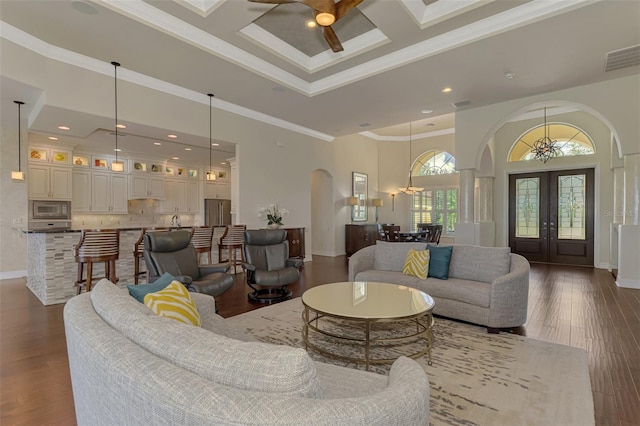 living room featuring a high ceiling, french doors, coffered ceiling, crown molding, and beam ceiling