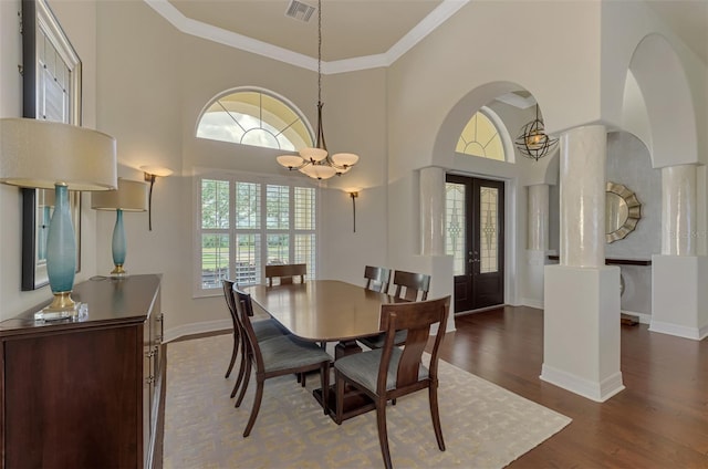 dining area featuring a chandelier, french doors, plenty of natural light, and ornamental molding