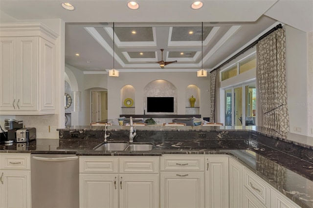 kitchen with dishwasher, sink, coffered ceiling, dark stone countertops, and ornamental molding