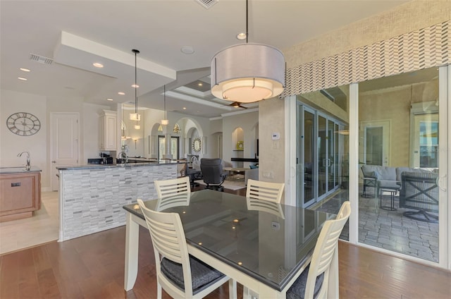 dining space with dark hardwood / wood-style floors and sink