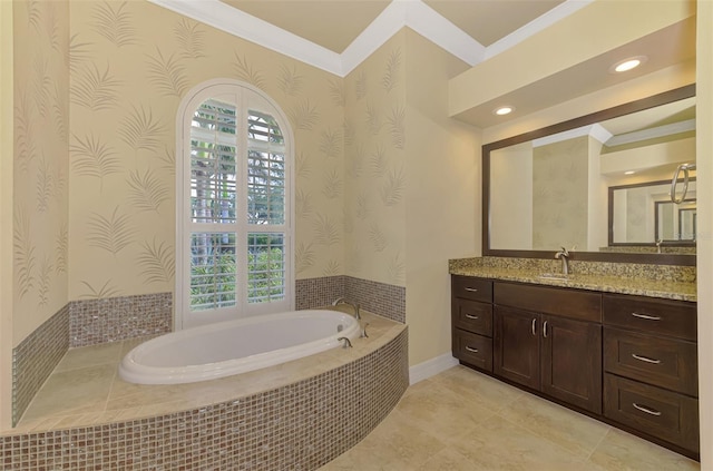 bathroom with vanity, crown molding, and tiled tub