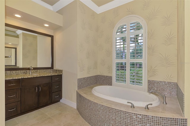 bathroom featuring vanity, a relaxing tiled tub, tile patterned floors, and crown molding