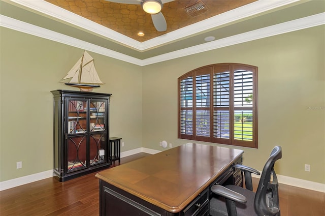 office with a tray ceiling, crown molding, ceiling fan, and dark wood-type flooring