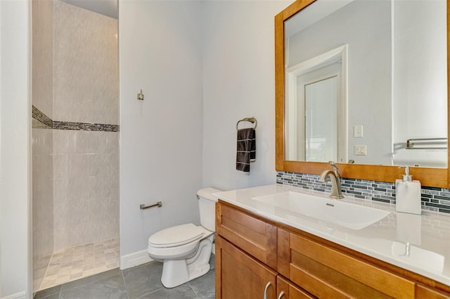 bathroom with a tile shower, tile patterned floors, backsplash, toilet, and vanity