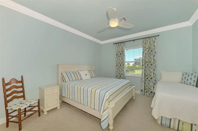 carpeted bedroom with ceiling fan and ornamental molding