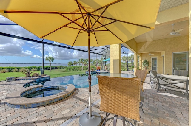 view of patio with ceiling fan, a pool with hot tub, and a lanai