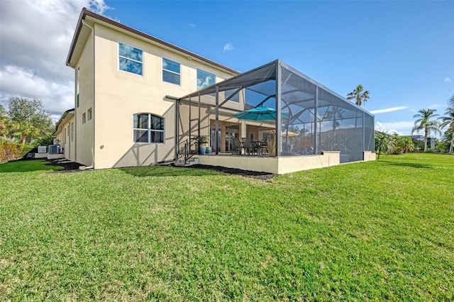 back of house featuring a yard and a lanai