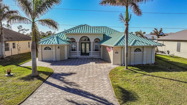 view of front of house featuring a front yard and french doors