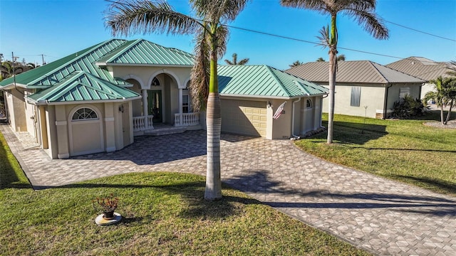 view of front of property featuring a garage and a front lawn