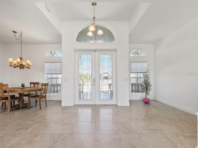 9567 Honeymoon Dr, Port Charlotte, FL 33981 - entrance foyer with french doors, a chandelier, a high ceiling, and light tile patterned floors