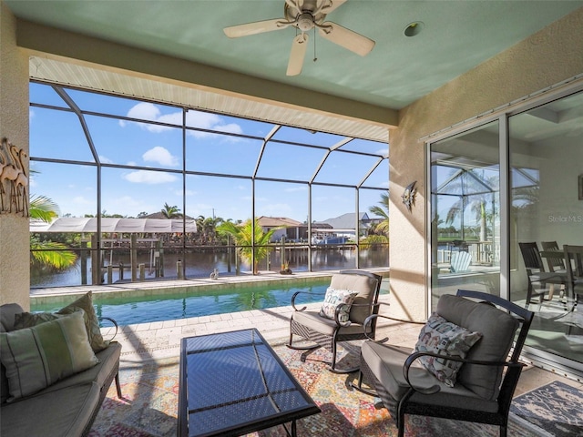 view of swimming pool with a patio area, ceiling fan, a water view, and an outdoor hangout area