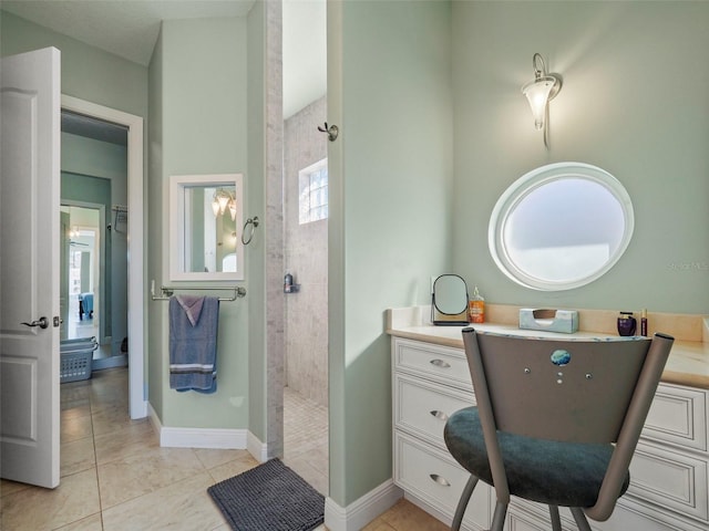 bathroom with tile patterned floors and tiled shower