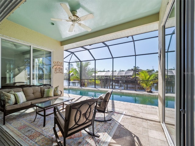 view of patio / terrace with an outdoor living space, a water view, glass enclosure, and ceiling fan