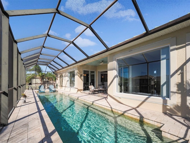9567 Honeymoon Dr, Port Charlotte, FL 33981 - outdoor pool featuring a patio area, a ceiling fan, and glass enclosure
