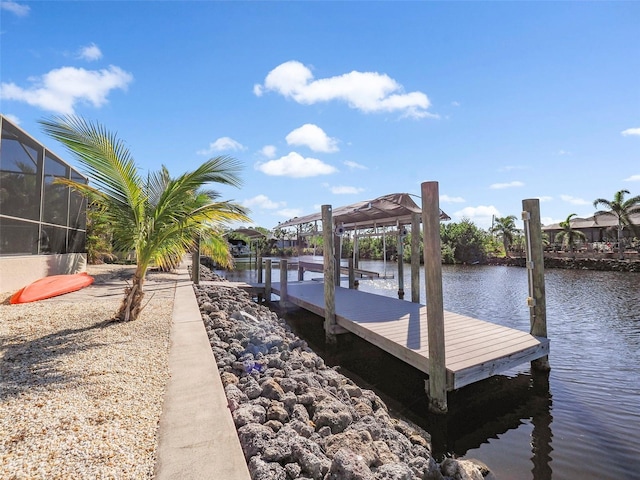 dock area featuring glass enclosure and a water view