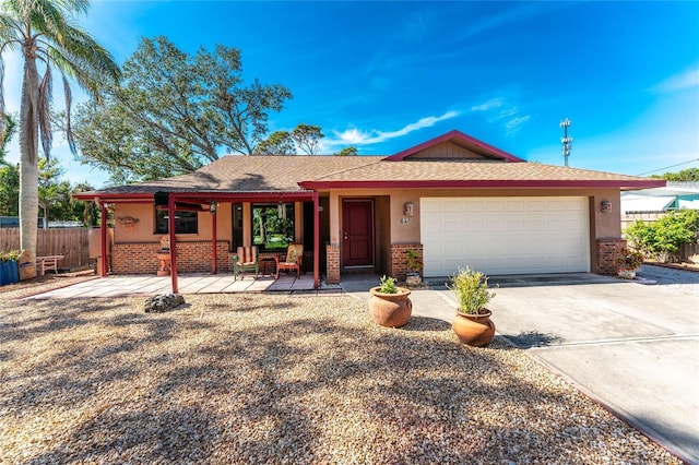 single story home featuring covered porch and a garage