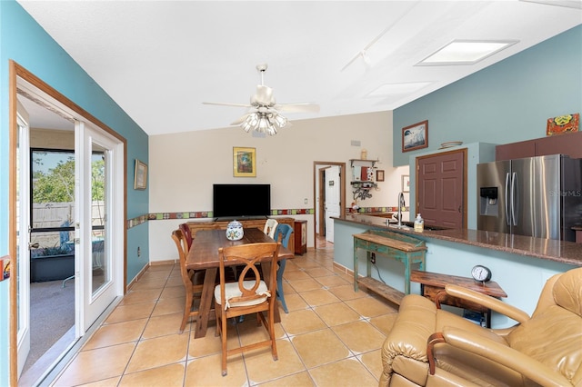 dining room featuring french doors, ceiling fan, sink, lofted ceiling, and light tile patterned flooring