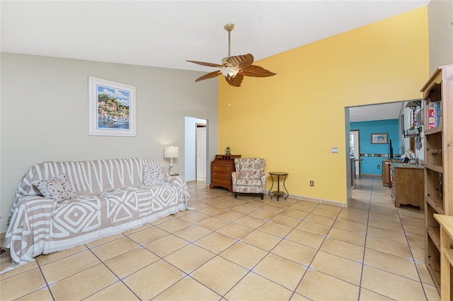 living room with light tile patterned floors, ceiling fan, and lofted ceiling