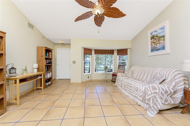 tiled living room featuring ceiling fan and vaulted ceiling