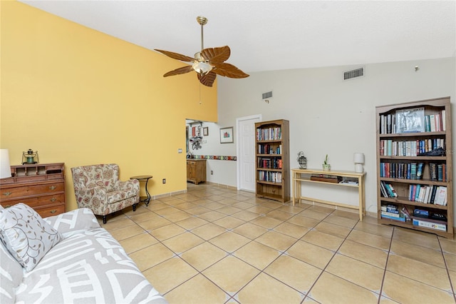 living room featuring ceiling fan, light tile patterned flooring, and vaulted ceiling