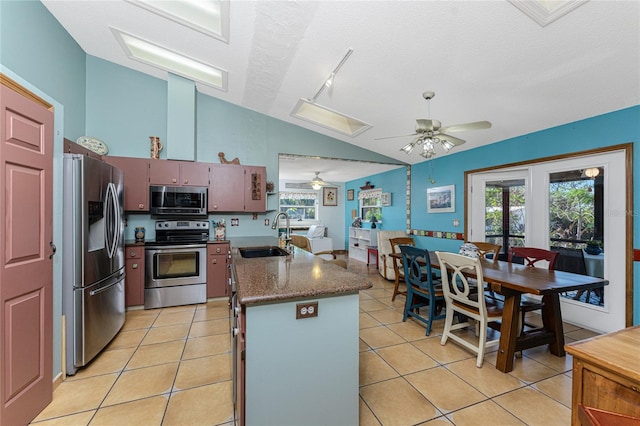 kitchen featuring french doors, sink, stainless steel appliances, a textured ceiling, and light tile patterned flooring