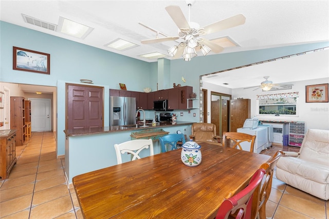 dining room featuring sink and light tile patterned floors