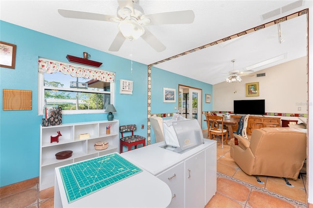 laundry area featuring light tile patterned flooring and french doors