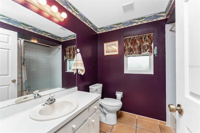 bathroom with vanity, a shower with curtain, tile patterned flooring, toilet, and a textured ceiling