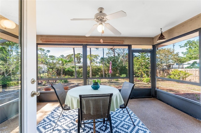 sunroom featuring ceiling fan and plenty of natural light