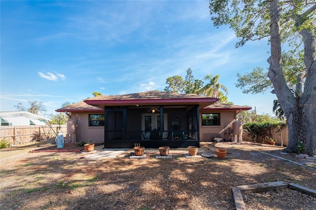 rear view of property with a sunroom