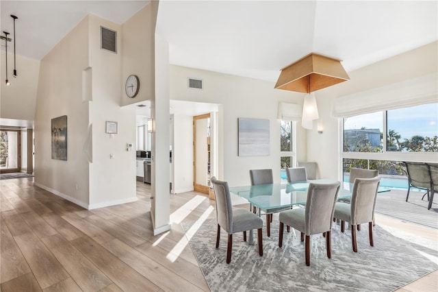 dining space featuring light hardwood / wood-style flooring and a healthy amount of sunlight