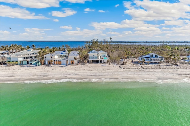 drone / aerial view with a water view and a beach view