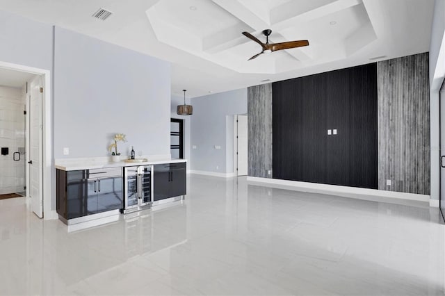 living room featuring coffered ceiling, wine cooler, indoor bar, ceiling fan, and beamed ceiling