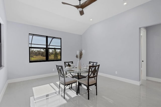 tiled dining area with ceiling fan and vaulted ceiling