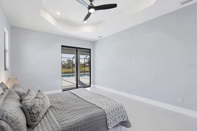 tiled bedroom with access to outside, ceiling fan, and a tray ceiling