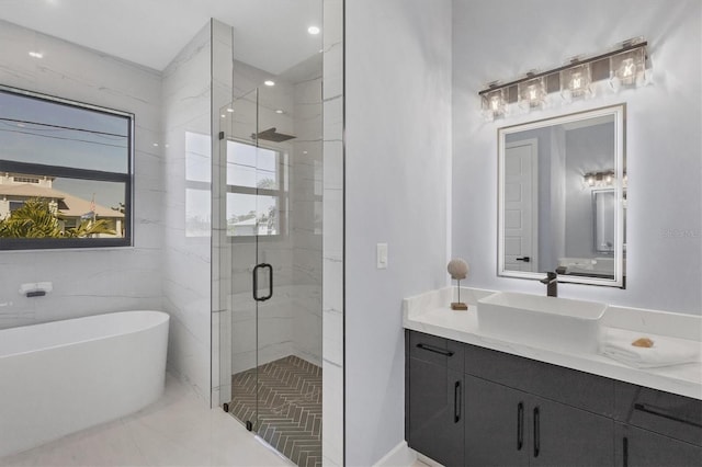 bathroom featuring vanity and shower with separate bathtub