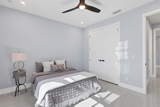 bedroom with ceiling fan and a closet