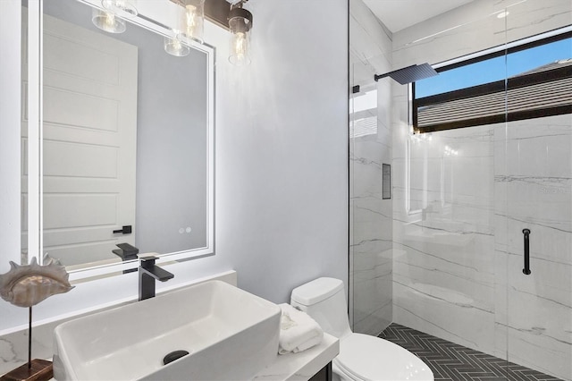 bathroom with vanity, toilet, and a shower with shower door